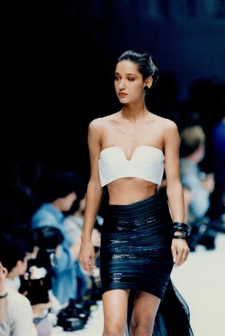 Right, Gianfranco Ferre bares the knees, midriff and shouders in a skin-tight black mini and bold white halter