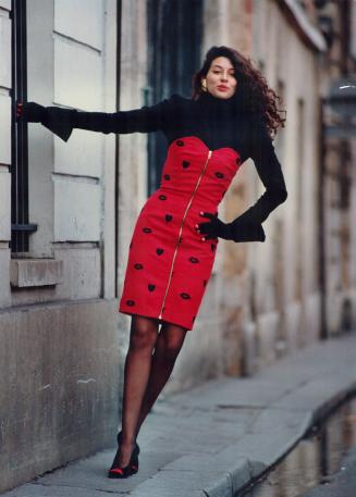 Above, Patrick Kelly's shapely lip motif wool jersey dress worn with gloves with painted nails