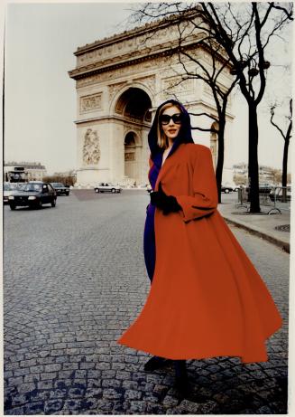 Above, purple hooded sweater and hip-hugging skirt, $875, topped by a cashmere-and-wool swing coat, $1,285, shows Khanh's love of color. Her. sunglasses: $150
