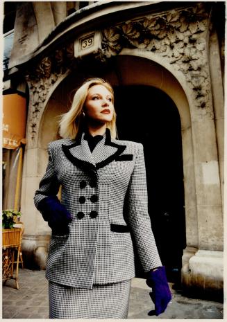 Left, from her fall line, a double breasted houndstooth suit with black velvet trim will be $875