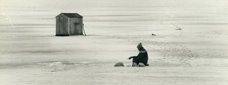 Star photographer Jeff Goode used a Nikon F3 with 85mm lens exposure 500th at F8 to shoot this strange sportsman on Lake Simcoe who decided to fish outside of his ice hut and brave the winter winds