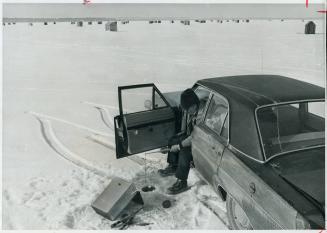 So who needs a hut? Really making tracks, Edward Tiltins of Toronto goes ice fishing by driving his car right out onto the middle of Lake Simcoe and s(...)