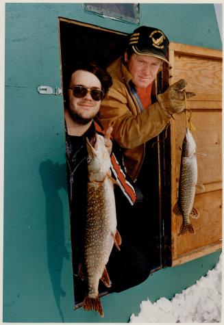 Gone fishing: Danny Brunato (left) and Bill Linders show off some of the early catch ice fishing at Virginia Beach on Lake Simcoe