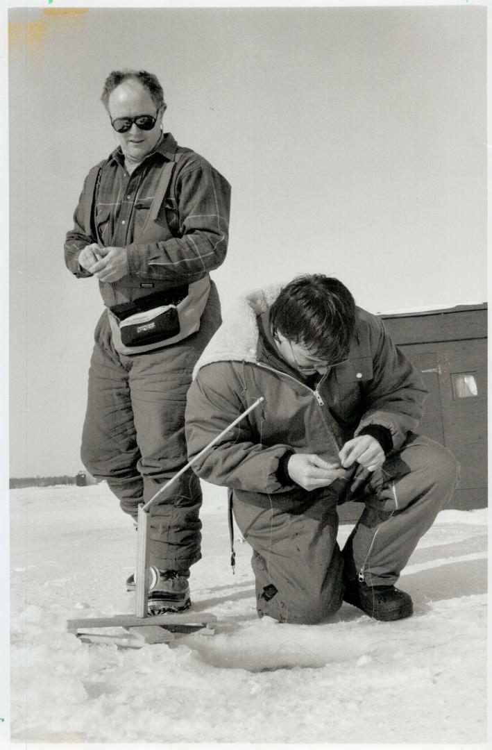 Frosty fishermen: Kevin Cunningham wets a line while Steve Warren gets ready to join him