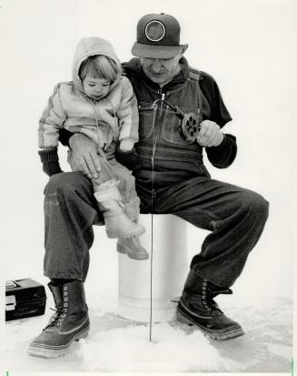 Fishin' with grandad: Samantha Plumbohm, 2, waits with grandfather walter Plumbohm for a fish to bite