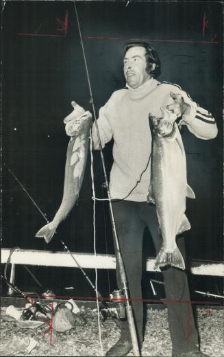 Fisherman Ken Read holds two of the catches of coho salmon he made at 2