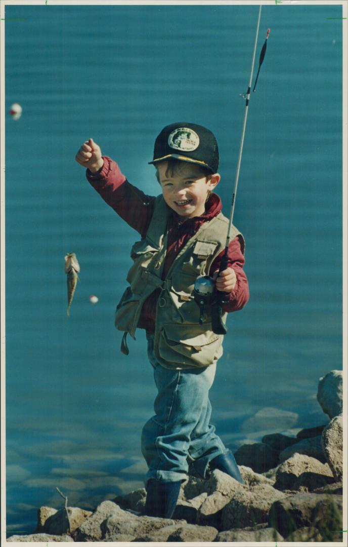 Caleb Moffat, 5, of Milton, beams with his first catch yesterday in a trout derby at Milton's Kelso Conservation Area