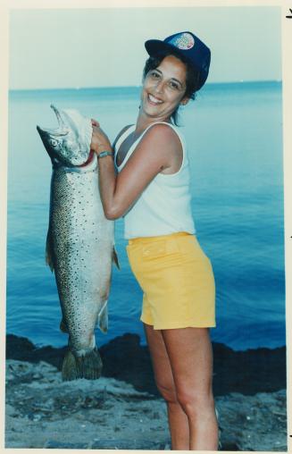 One for record books. Pam Harvey of Mississauga hoists the record 25.68-pound brown trout she caught off Oakville yesterday - the first fish she'd ever caught