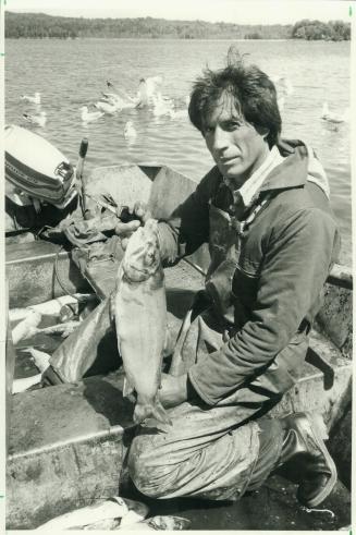 Commercial fisherman Marshall Nadjiwon displays a Georgian Bay Splake