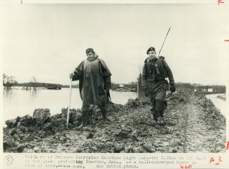 Soldiers from Princess Patricia's Canadian light infantry patrol the dike protecting Emerson looking for leaks or other weaknesses