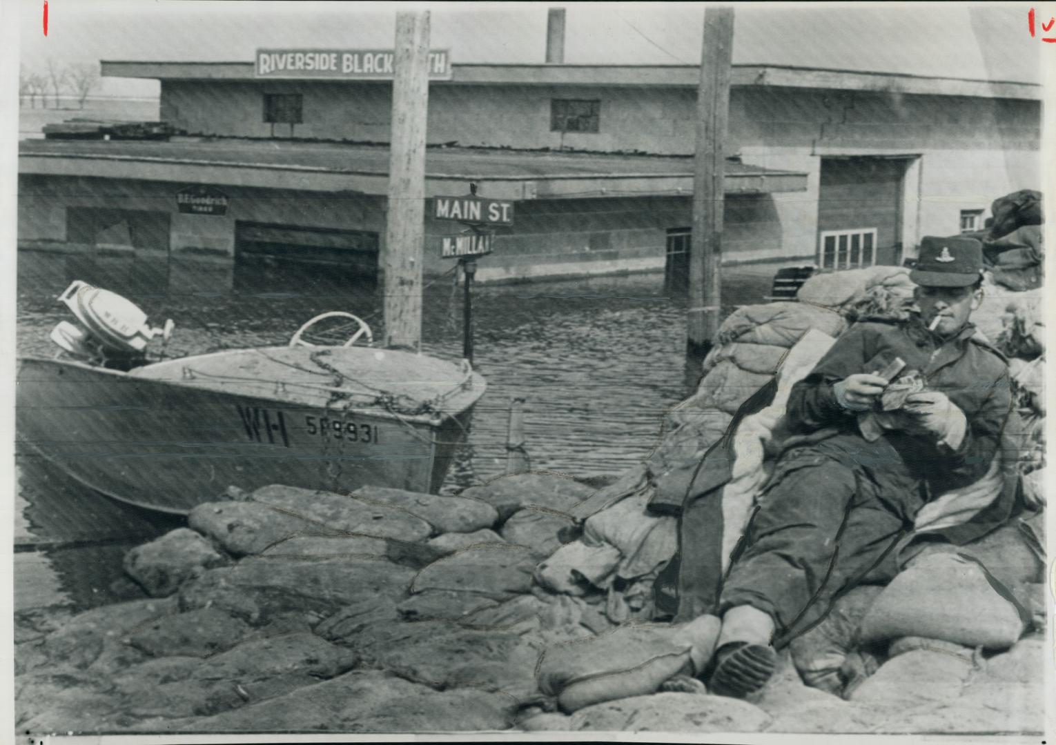 A soldier relaxes at Morris, Halfway point between emerson and winnipeg, beside red river dyke