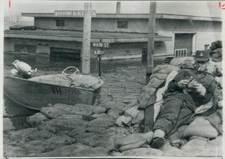 A soldier relaxes at Morris, Halfway point between emerson and winnipeg, beside red river dyke