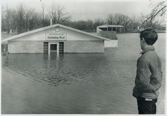 Ronald Whitwell surveys flooded Emerson athletic field