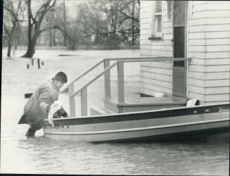 Back door sailors, A Tecumseh Road resident bails his boat at the back door of his floor surrounded home about 18 miles east of Windsor Ontario
