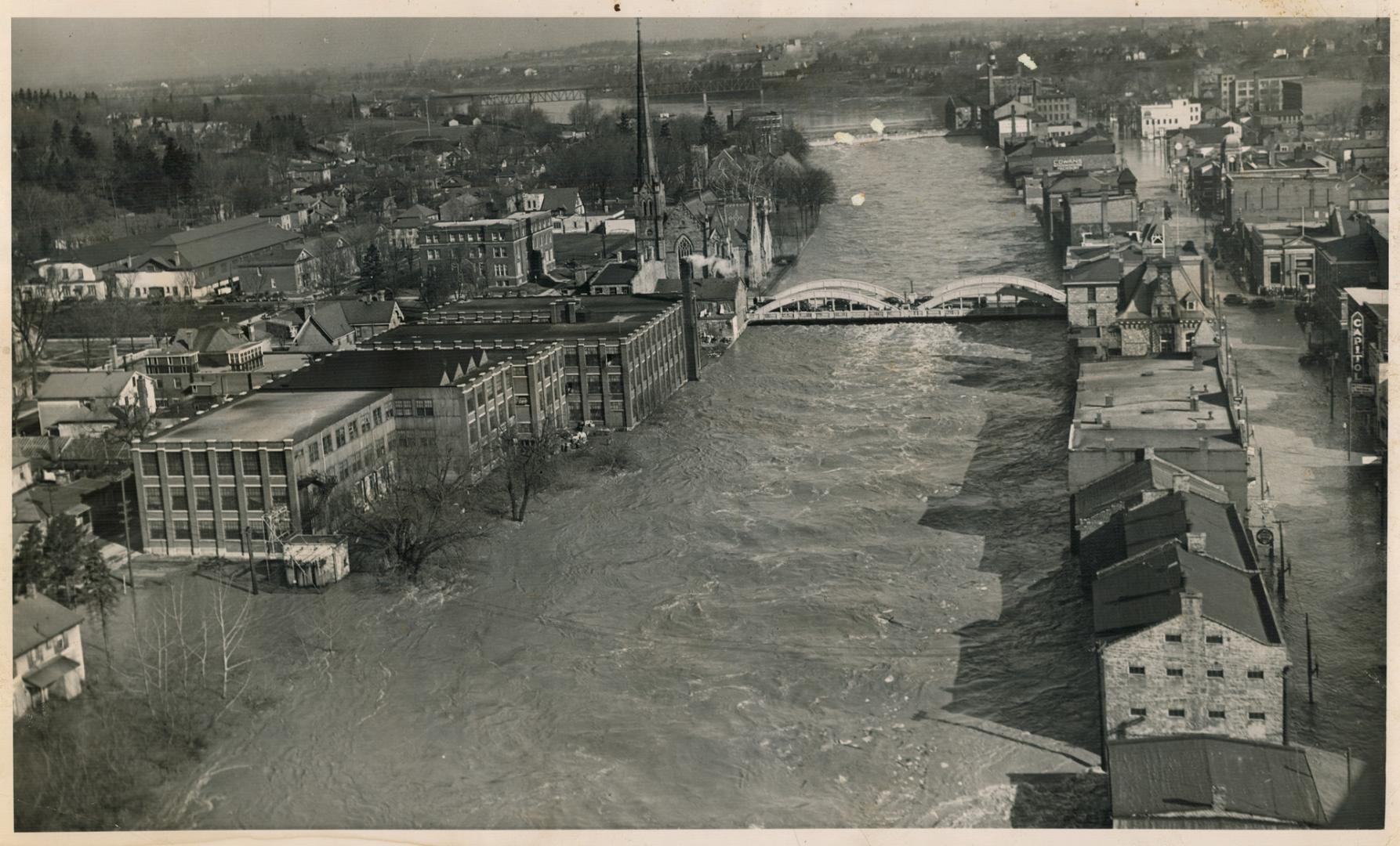 Rising 17 feet above its normal depth, the Grand river is shown here at Galt