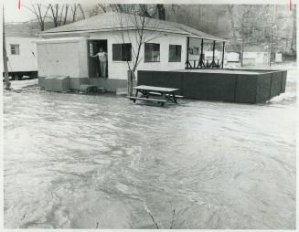 The spring runoff, combined with yesterday's downpour, has turned the Credit River into a swollen, ragining torrent that has overflowed its bank in ma(...)
