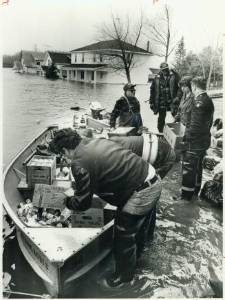Foodstuffs carried by boat for flood workers in Field, Ont