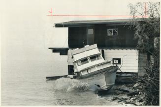 Torn from its moorings at Oakville Power Boat Club in last night's storm, the Playmate, a cabin cruiser owned by Allan Archer of Burlington, was carri(...)