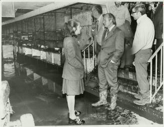 Boots muddied after a 1 1/2-hour tour today of flood-ravaged Cambridge, Premier William Davis tells the city's mayor, Claudette Millar (left), that th(...)