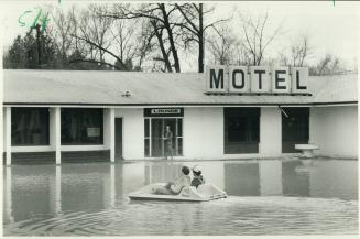 Peddling along: Steve Brittain and Joe Hill find it's easier to get around the parking lot at Moodie's Motor Inn in the Pickering area in a pedal-boat than in a car