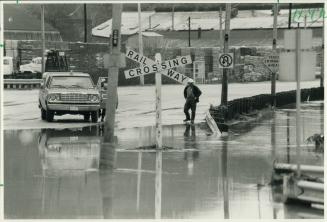 Under water: Railway workers check the tracks near the Bayview Extension to make sure they are clear of debris before trains could use them again