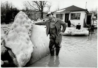 Flood danger: Keith Hay stands beside some of the ice from the swollen Humber River that threatened to tear apart of his home in the Kleinburg area last week