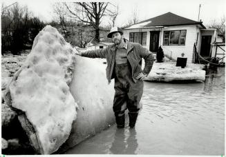 Flood danger: Keith Hay stands beside some of the ice from the swollen Humber River that threatened to tear apart of his home in the Kleinburg area last week