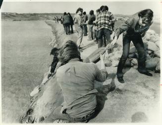 To keep ahead of the flood-swollen Qu'Appelle River while it threatens Lumsden, Sask