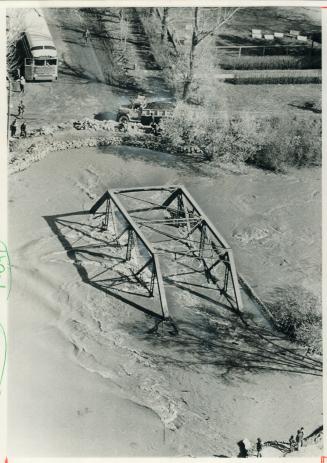 The flood-swollen Qu'Appelle River surges through Lumsden, Sask