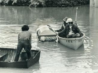 A coffin that floated away from a funeral home is towed to dry land in Corning, N