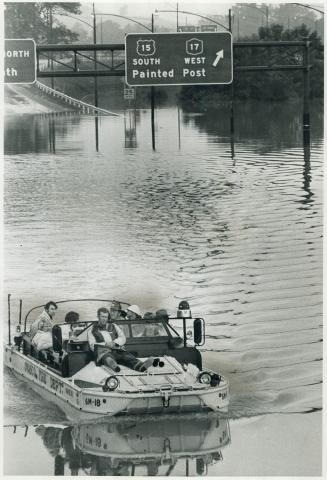 Fire department boat on rescue duty sails along Highway 15 near Corning, N