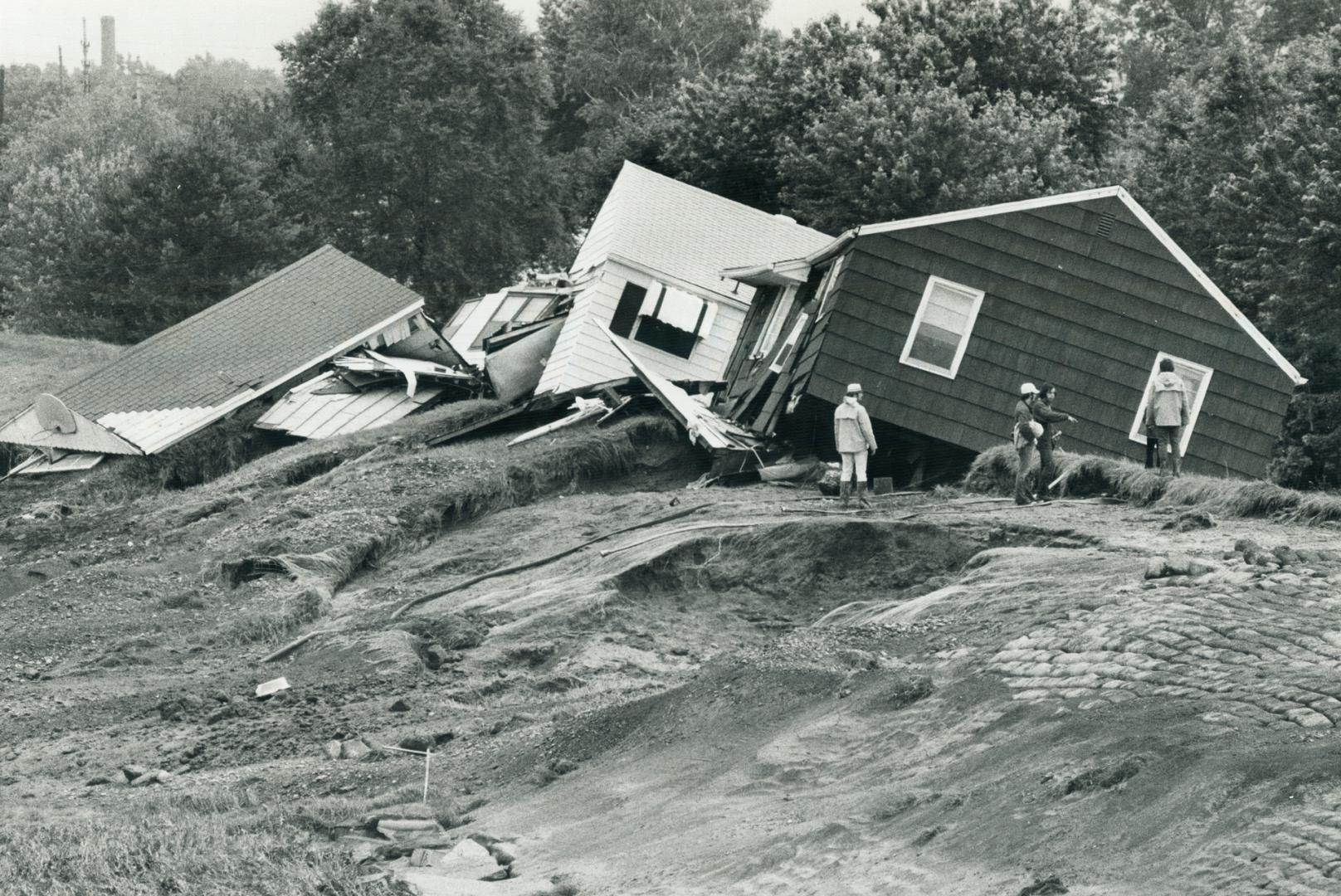 12 Corning, These houses were smashed to pieces after they were wrenched from basements and carried away by flood waters. They're resting on top of a dike