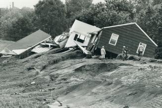 12 Corning, These houses were smashed to pieces after they were wrenched from basements and carried away by flood waters. They're resting on top of a dike