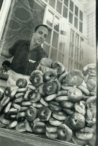 Hundred of bagels are sold daily at the Perlmutar Bakery, Morris Perlmutar checks his supply