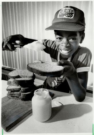 Don't hold the mayo: Kevin Gumbs, 11, gets set to spread a big dollop of mayonnaise on his sandwich, a safe summer practice, a nutrionist says