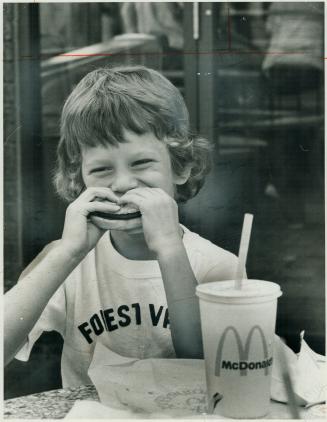 Mark Cohon, 6, Takes big bite. Young set always enjoys hamburgers