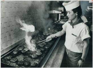 Hungry strollers on Yonge St., will soon be enjoying these hamburgers Peter Georgopoulos is broiling. Ground beef is also the favorite choice for fami(...)