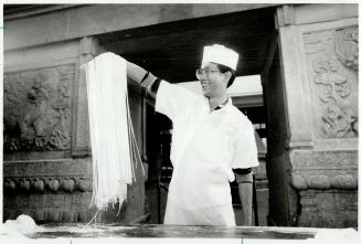 Chinese noodles: Above, Danny Chu whps the dough over his head like a skipping rope