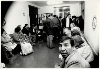 Rich and poor, The bleak line of people waiting for supplies at a Metro food bank contrast with a joyful year-end celebration at the Toronto stock exchange