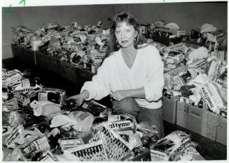 Helping hand: Bonnie Hart at Oshawa's Simcoe Hall Setlement House prepares food boxes for the needy in a city used to one of the nation's lowest unemployment rates