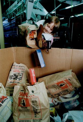 Julie Holt, 5, delivers donations in a Star food drive bag to No