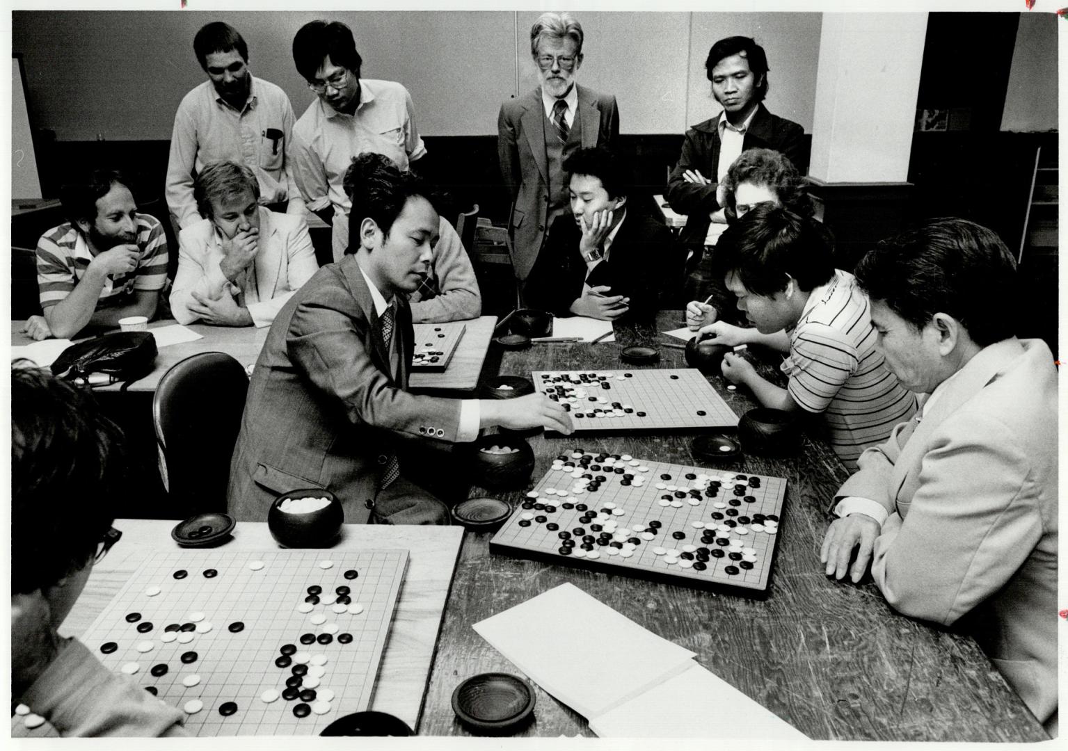 Professional at work: Isamu Haruyama, 36, a professional Go player from Japan, took on several players at a time in Metro last week