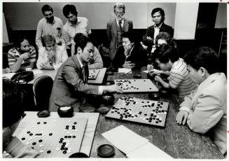 Professional at work: Isamu Haruyama, 36, a professional Go player from Japan, took on several players at a time in Metro last week