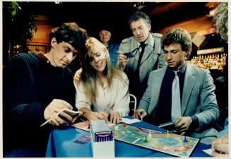Torontonians Paul Toyne, left, and Robinson play their game Balderdash, a favorite of the cast of TV show Night Heat, with stars Jeff Wincott, right, and Scott Hylands