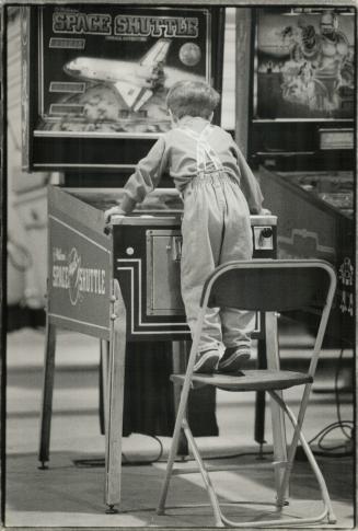 Pinball wizard. Mere lack of money can't stop Daniel Hamilton, 3, of Toronto from playing the games yesterday at the Kids' Carnival at the Metro East Trade Centre
