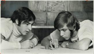 Tiddleywinks experts Mel Salmon (left) and Bryan Alexandroff, members of University of Toronto Engineering Society Tiddlywinks Team, concentrate on a (...)