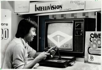 Played out: Abang Adzhar, 22, tests his skill on an Intellivision video baseball game hooked up to a television set in a local retail outlet