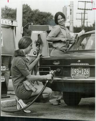 Gas bar maids Sandi Sharp fills up a car at a Bayview service station while Wendy Barker gives the rear window a thorough cleaning. The two 16-year-ol(...)