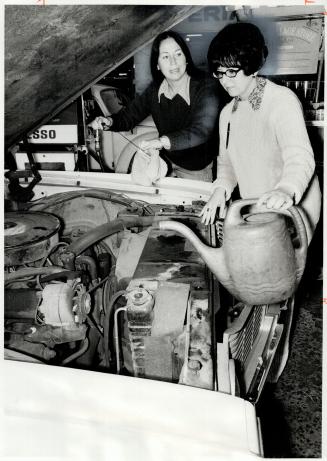 Pat, Left, and Sandra Morgan check Oil and Radiator, They operate their late father's service station on Gerrard St