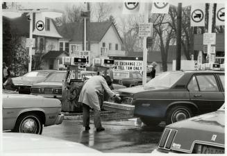 Fill 'er up: Motorists from the United States, above, fill up their cars with cheapter Canadian gas at Fort Erie service station